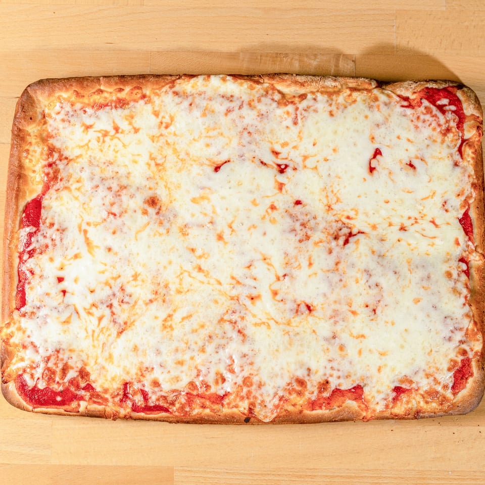A rectangular cheese pizza from La Pizzeria, with melted white and golden cheese over red sauce.