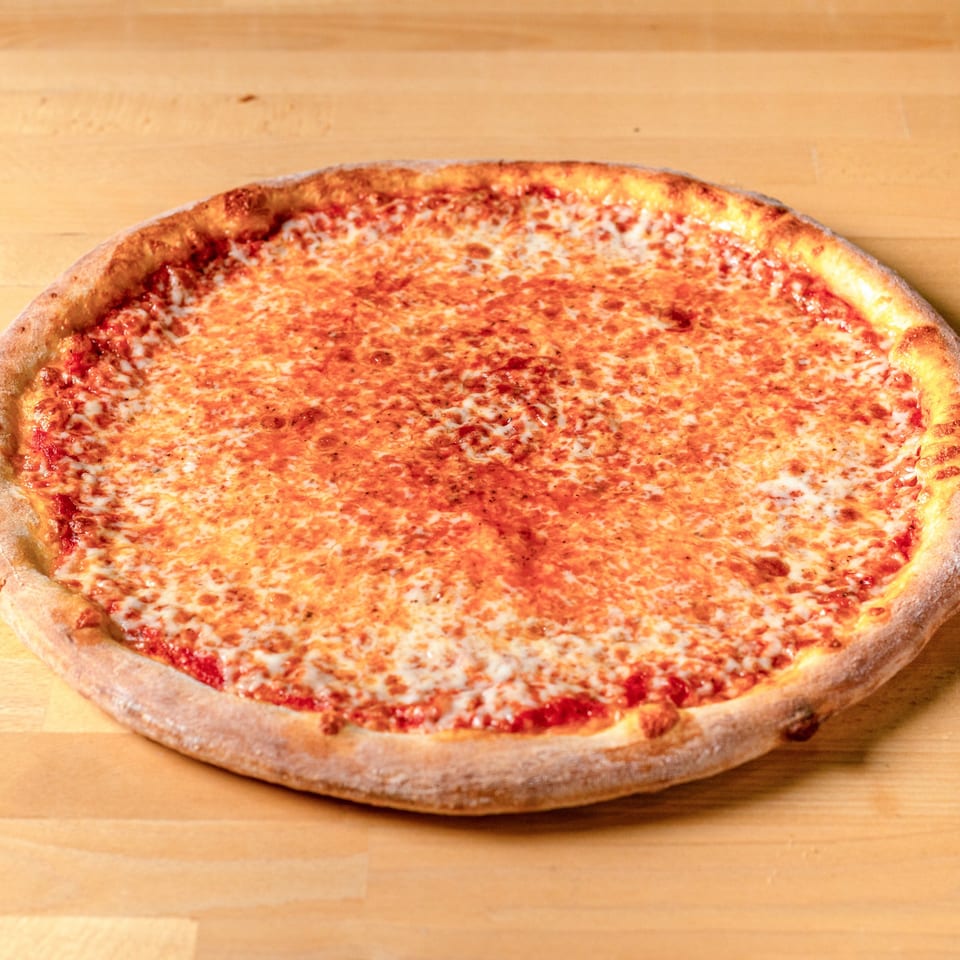A whole cheese pizza from La Pizzeria, with a golden crust and melted mozzarella, on a wooden table.